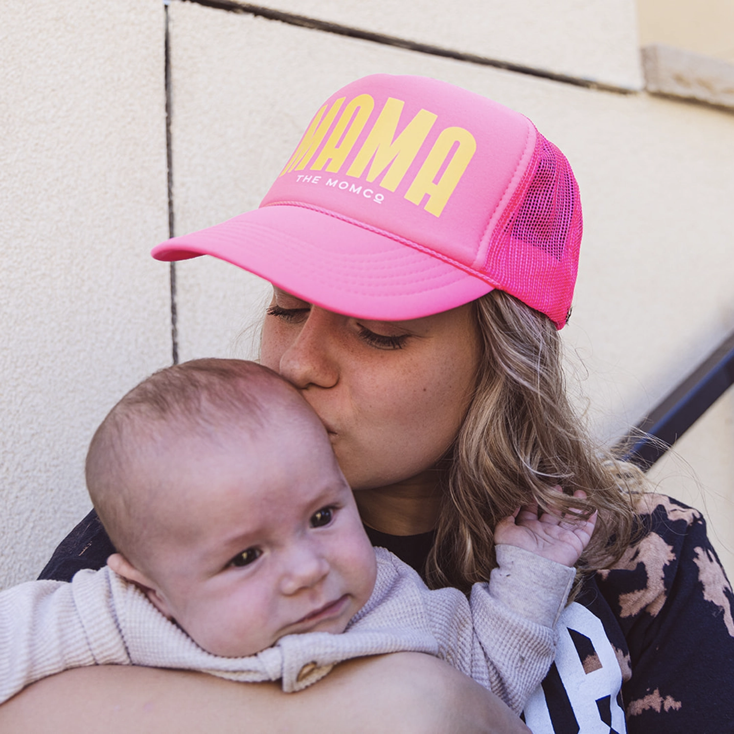 woman holding momco branded water bottle